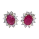 Pair of 9ct gold oval ruby and diamond cluster stud earrings, total ruby weight approx 3.85 carat