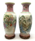 A pair of large Chinese famile rose style vases, one decorated with figural scene, the other with mo