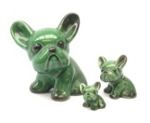 A graduated set of three Denby green glazed dogs, largest marked beneath, largest H15cm.