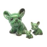 A graduated set of three Denby green glazed dogs, largest marked beneath, largest H15cm.