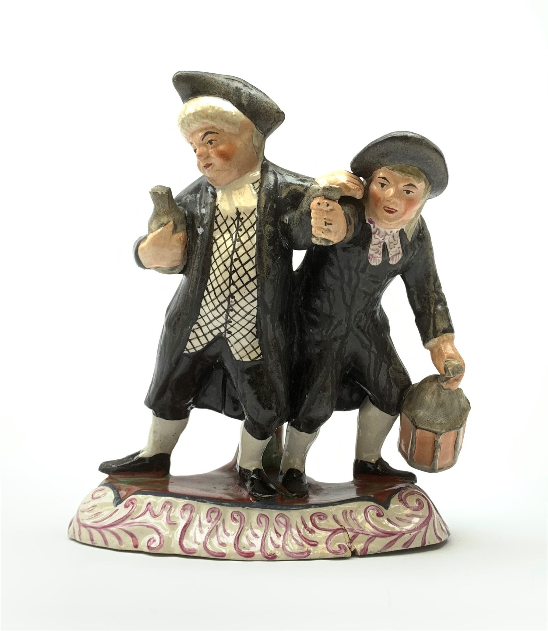 A 19th century Staffordshire figure group, 'Town Crier and Drunk', upon oval scroll detailed base, H