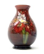 A Moorcroft flambé vase, of baluster form decorated in the Orchid pattern, with impressed mark and R