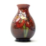 A Moorcroft flambé vase, of baluster form decorated in the Orchid pattern, with impressed mark and R