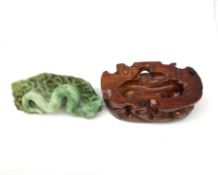 A carved jade serpent on stylised base, with accompanying carved stained wooden stand, figure L11cm.
