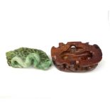 A carved jade serpent on stylised base, with accompanying carved stained wooden stand, figure L11cm.