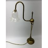 A brass students lamp, with adjustable swan neck and crackle effect clear glass frilled shade, H70cm