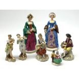 Four Sitzendorf figurines, comprising two examples modelled as two of Henry VIII's wives, a smaller