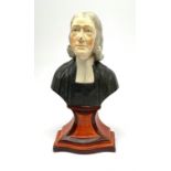 A Staffordshire bust, modelled as John Wesley, upon spreading base, H24.4cm.