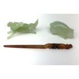 A carved jade pig, L6.5cm, together with a carved jade horse, L10cm, and a russet jade hair pin with