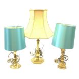 Three gilt table lamps, to include one example with acanthus detailed stem, each with shade, largest