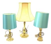 Three gilt table lamps, to include one example with acanthus detailed stem, each with shade, largest