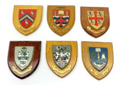 Three shield shaped university wall plaques, comprising St Edmund Hall, Oxford, University of Maches