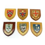 Three shield shaped university wall plaques, comprising St Edmund Hall, Oxford, University of Maches