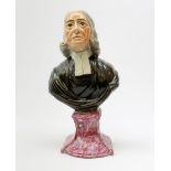 A 19th century Staffordshire pearlware bust, modelled as John Wesley, upon spreading base, H26.5cm.