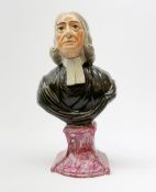 A 19th century Staffordshire pearlware bust, modelled as John Wesley, upon spreading base, H26.5cm.