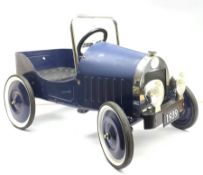 A blue painted metal pedal car, modelled as a 1930s motor vehicle, with a moulded plastic seat, sing