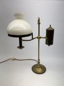 A brass students lamp, with adjustable arm supporting counter weight and white glass shade, H49cm.