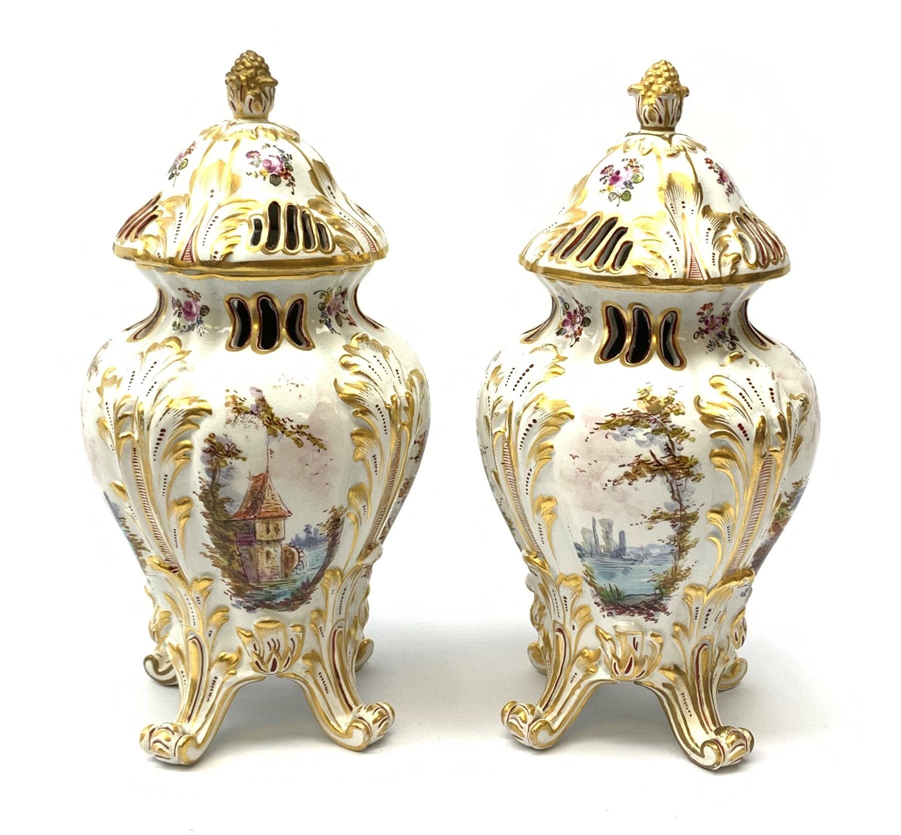 A pair of Continental porcelain vases and covers, each of baluster form raised upon four scroll feet
