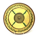 Vallauris Pottery wall plate or small charger, of circular form, the yellow ground with stylised dec