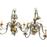 Two brass Flemish style chandeliers, each with six curved branches detailed with fish, largest H63cm