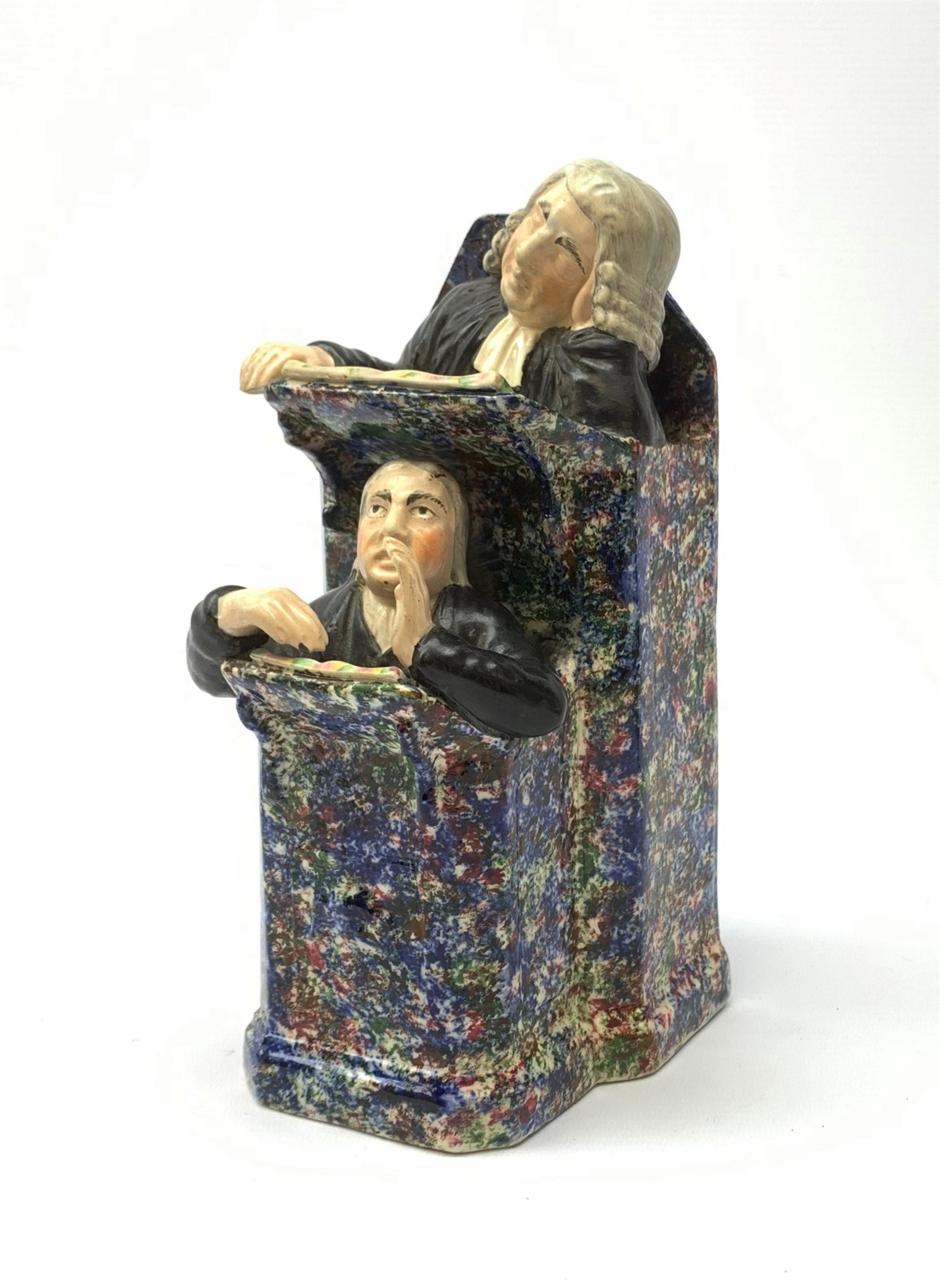 A 19th century Staffordshire figure group, modelled as a sleeping judge and clerk, H24cm.