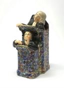 A 19th century Staffordshire figure group, modelled as a sleeping judge and clerk, H24cm.