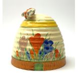 A Clarice Cliff Newport Pottery honey pot, modelled in the form of a beehive and decorated in the Cr