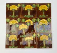 Ten Art Nouveau tiles, each decorated with stylised yellow and green flowers upon a brown ground,15c