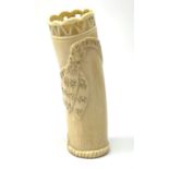 An African carved ivory spill vase, of cylindrical form with pierced rim and gadrooned band to base,