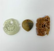 Two Russet carved jade pendants, one with zoomorphic detail, the other with floral detail, largest H
