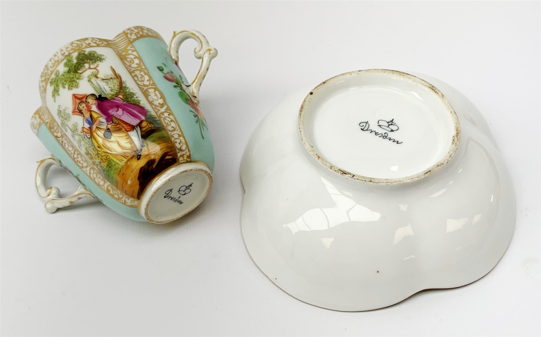 A Helena Wolfsohn Dresden porcelain quatrefoil twin handled chocolate cup and stand, painted with pa - Image 3 of 3