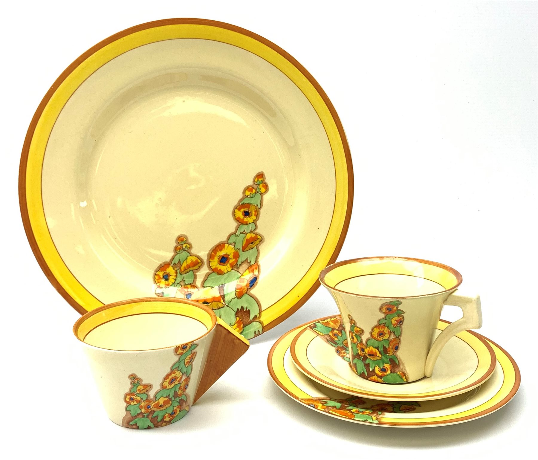 A Clarice Cliff Bizarre by Wilkinson Limited dinner plate, trio and cup in the Sunshine pattern. (5)