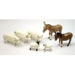 A group of Beswick figures, comprising two Charlie Wall Queen pigs, and a Charlie Wall Boy pig, two
