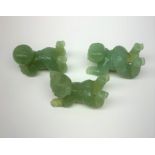 Three carved jade figures modelled as babies, approximately L5cm. (3).