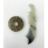 A white Hetian and black jade bi disc with carved detail, D5.5cm, together with a white Hetian and b