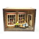 A 1/12th scale diorama of a toy shop window, depicting three children outside 'Adelaide's Toy Shop',