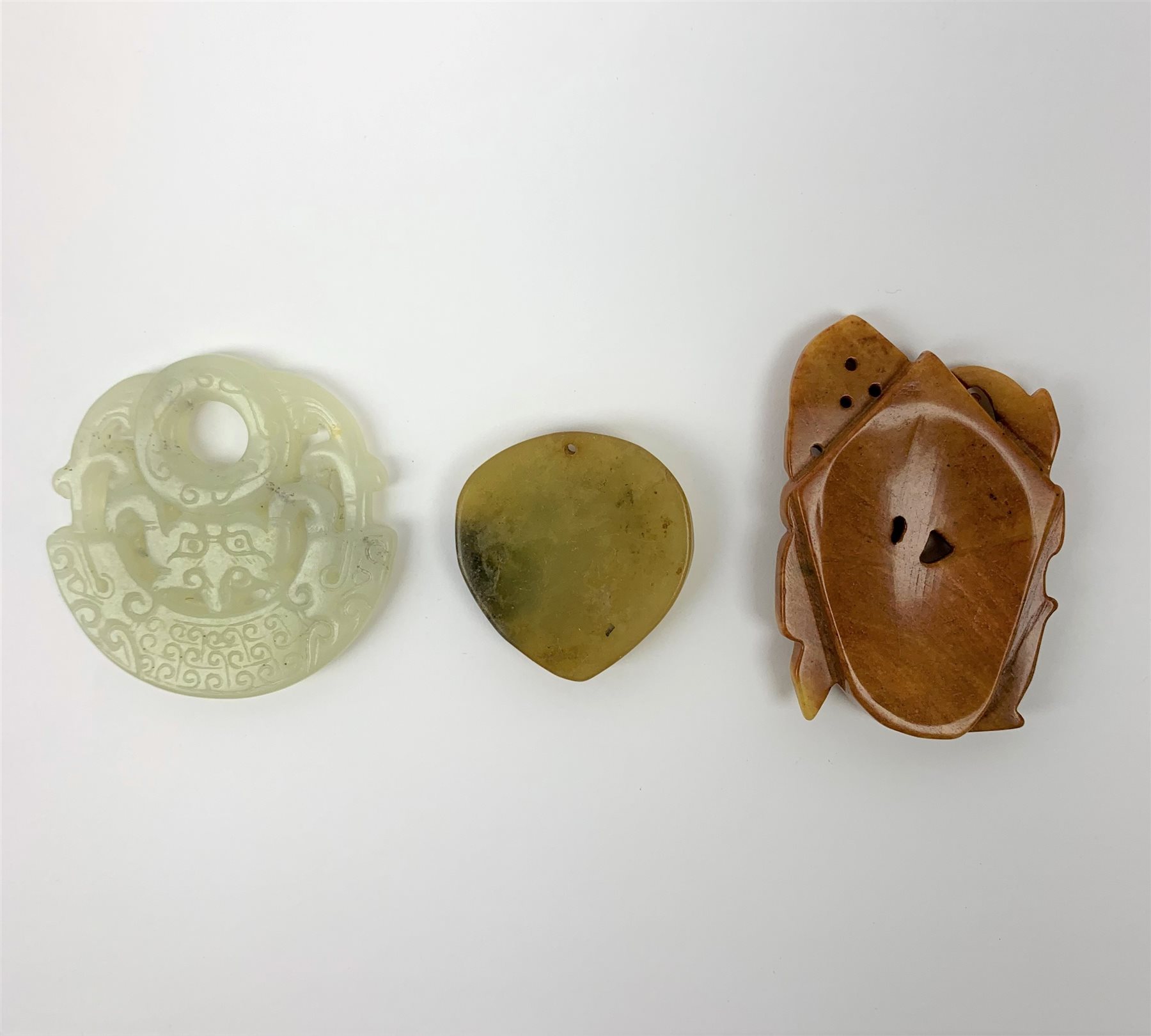 Two Russet carved jade pendants, one with zoomorphic detail, the other with floral detail, largest H - Image 2 of 2