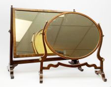 An Edwardian mahogany dressing table mirror, the oval mirror plate in swing frame, upon flared legs