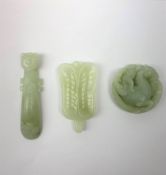 A carved celadon jade belt hook, L9.5cm, together with a celadon jade disc with carved zoomorphic de