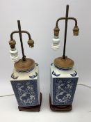 A pair of blue and white table lamps, of square sectional form decorated with dragons, prunus blosso