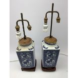 A pair of blue and white table lamps, of square sectional form decorated with dragons, prunus blosso