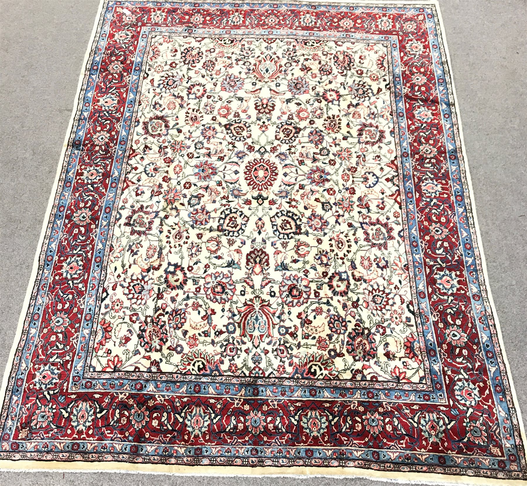 Persian Hamadan red and ivory ground rug, repeating border, central medallion in field of trailing f