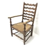 Early 20th century oak fireside armchair, shaped ladder back, reeded drop in seat, turned supports j