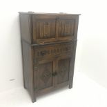 Mid 20th Century oak cocktail cabinet, carved drop front enclosing mirrored interior above single dr