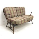 Ercol beech two seat Windsor settee, upholstered back and seat, turned supports, W130cm