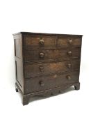 Early 19th century oak and mahogany banded chest, two short and three long drawers, shaped apron on