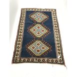 Turkish blue ground rug, three central medallions, 197cm x 134cm