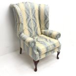Wing back armchair upholstered in light blue and pale gold striped fabric, cabriole feet, W85cm