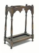 Early 20th century oak stick and umbrella stand, three divisions, turned supports, with metal drip t