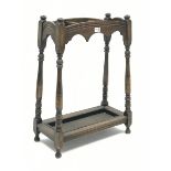 Early 20th century oak stick and umbrella stand, three divisions, turned supports, with metal drip t